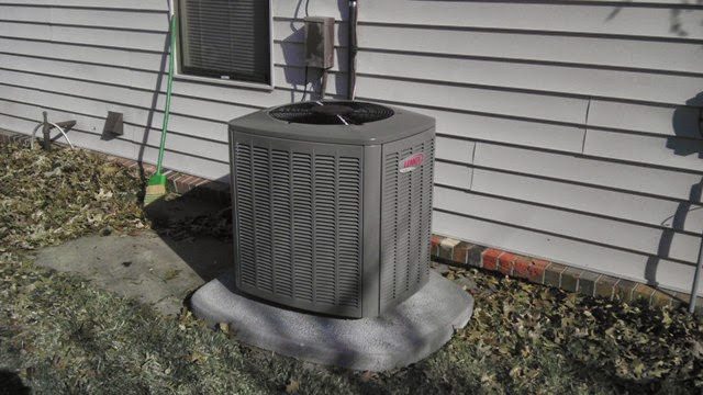 Lennox condenser unit installed beside a home