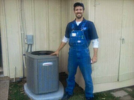 A Master Service technician beside a newly installed Lennox air conditioner