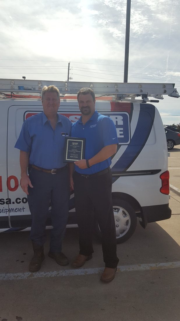 Steve and the Master Service team holding an American Standard Outstanding Dealer award